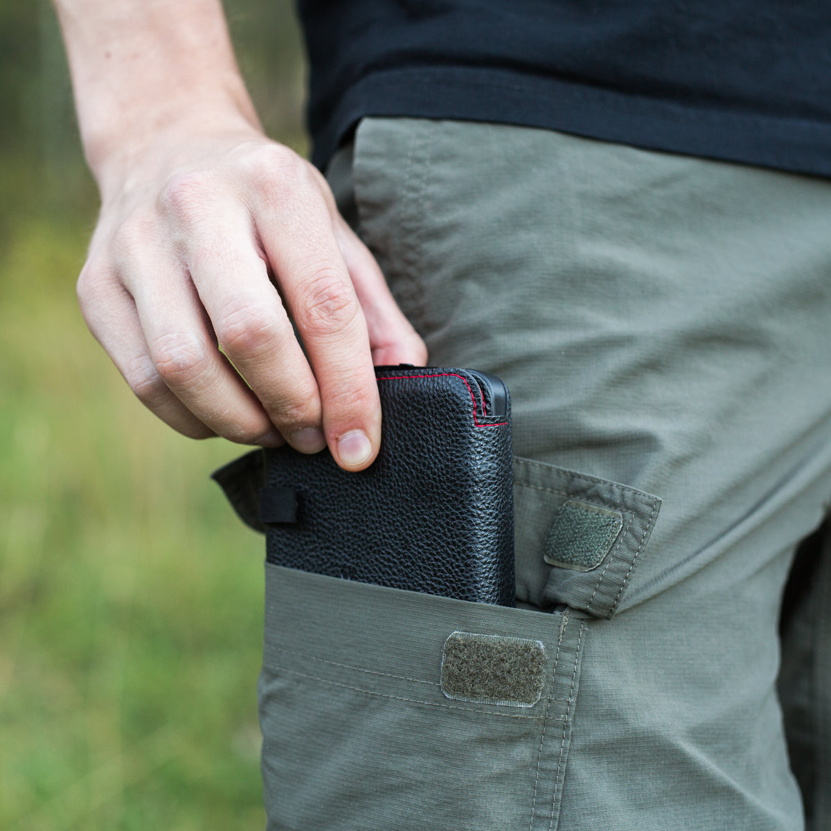 QuadraPro Solar Power Bank folded being put into man's pocket