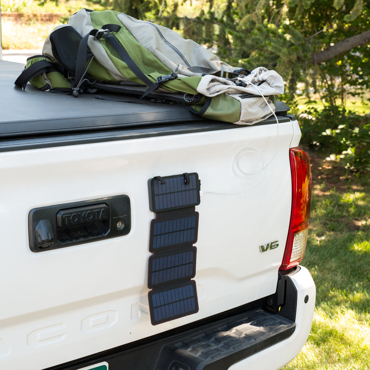 QuadraPro Solar Power Bank magnetic hanging on truck tailgate