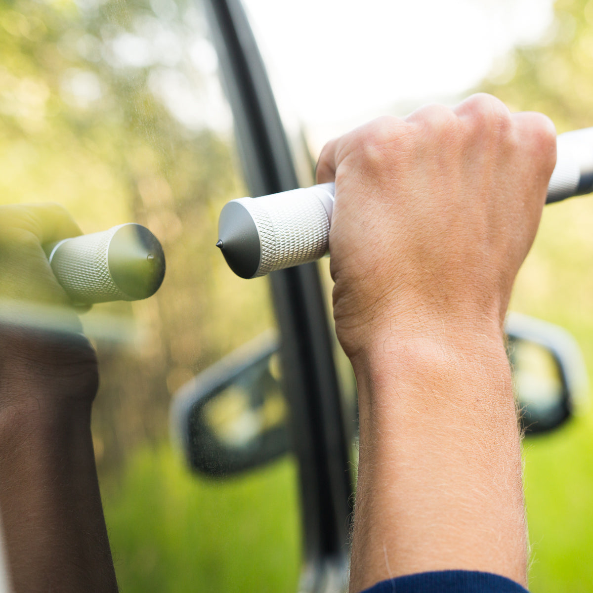 Tactical Shovel about to break window with window breaker tip on end of the shovel