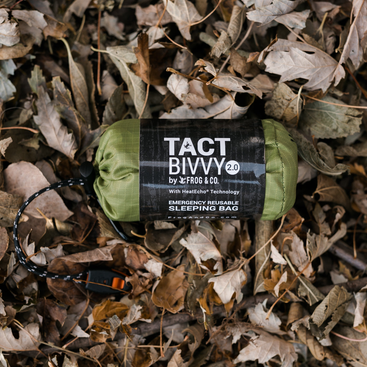 green bivy in leaves with grey sleeve