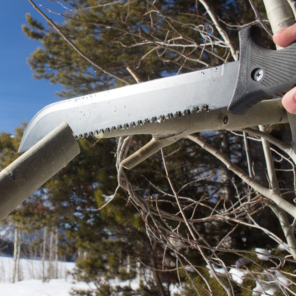 Machete sawing tree