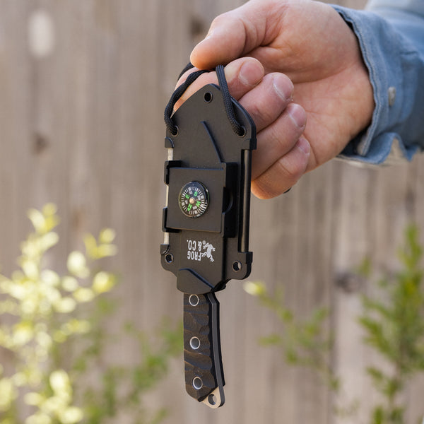 Neck knife being held in man's hand