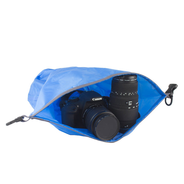 Open dry bag with a camera and lens inside