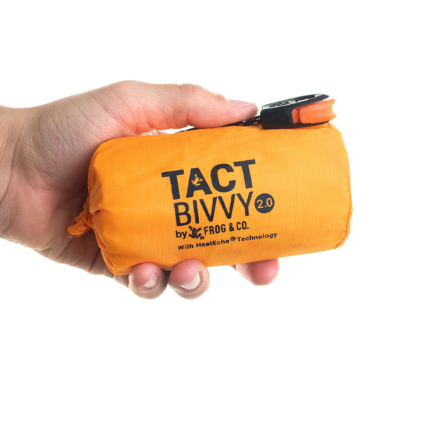 orange bivy held in left hand