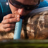 Man using LifeStraw Personal Water Filter in water
