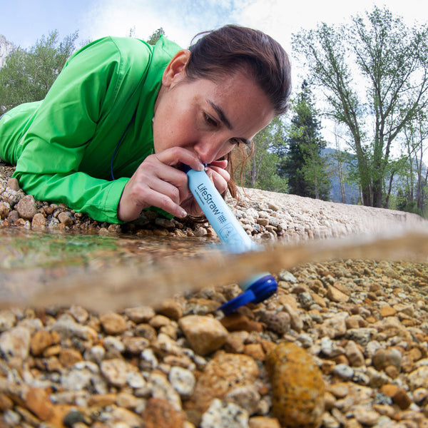 LifeStraw Personal Water Filter Woman using in stream