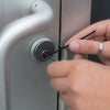 man using lock pick set on door lock