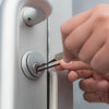 man using lock pick set on door lock