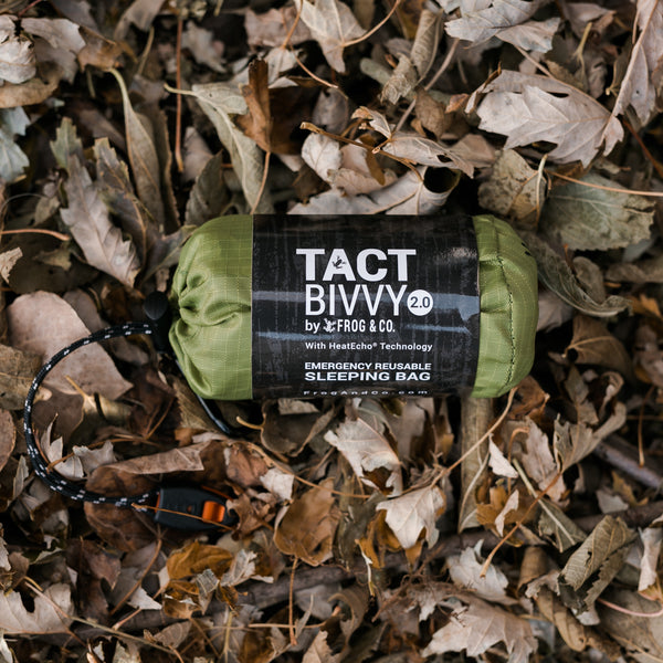 green bivy in leaves with grey sleeve