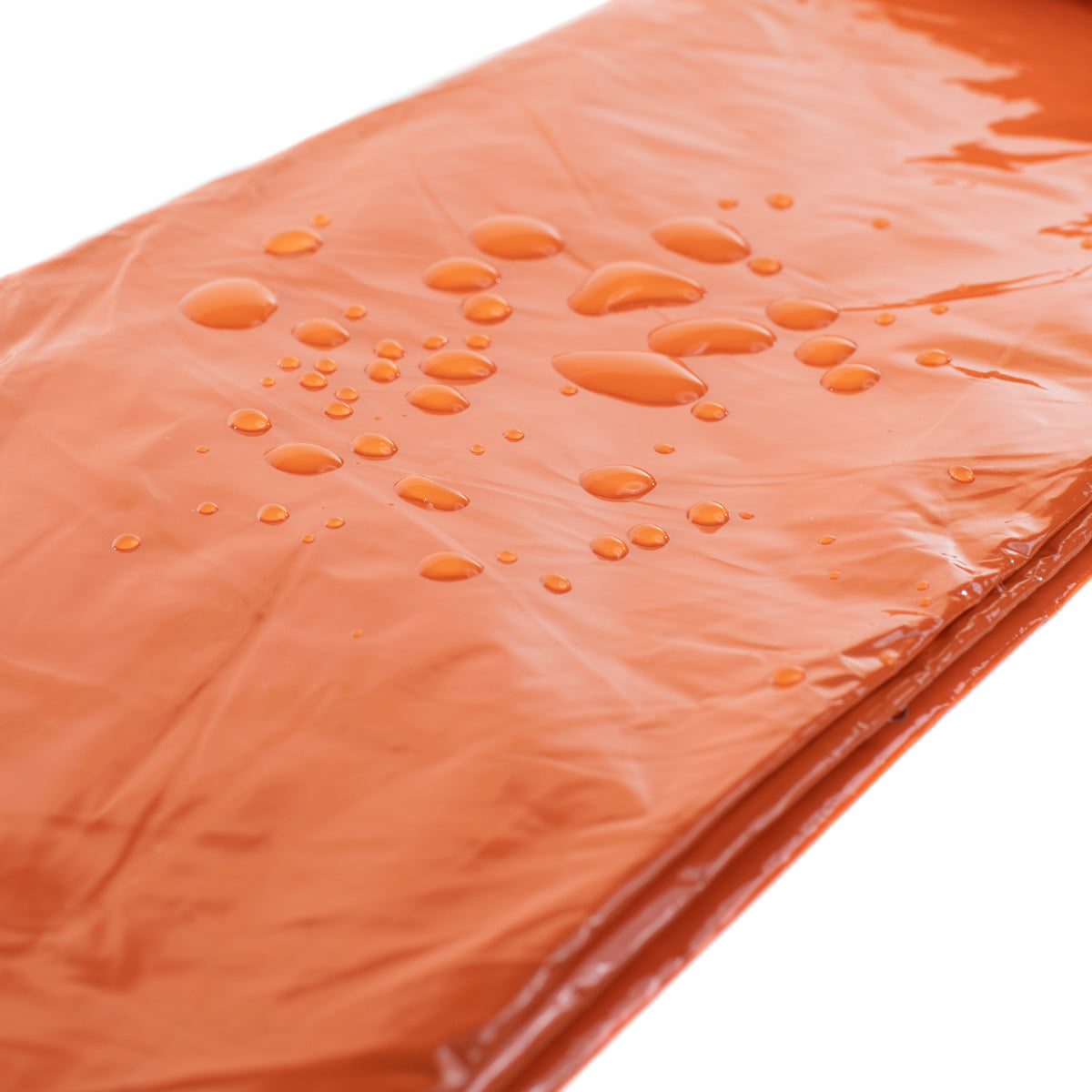 flat orange bivy with water drops