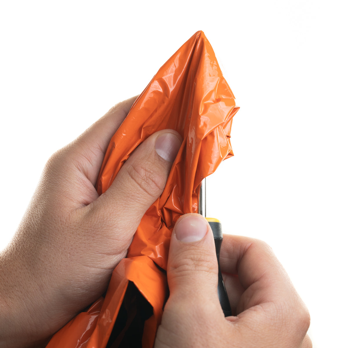 orange bivy in hand with screw driver trying to pierce through