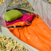 outdoor orange bivy in tent around sleeping bag
