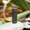 Outside image of waterproof matches case close sitting on a rock